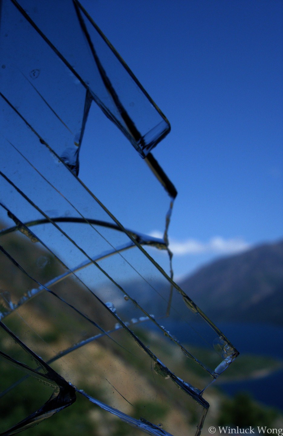 Broken window view photo for "Cottage For Sale" poem by Winluck Wong, writer residing in New Brunswick