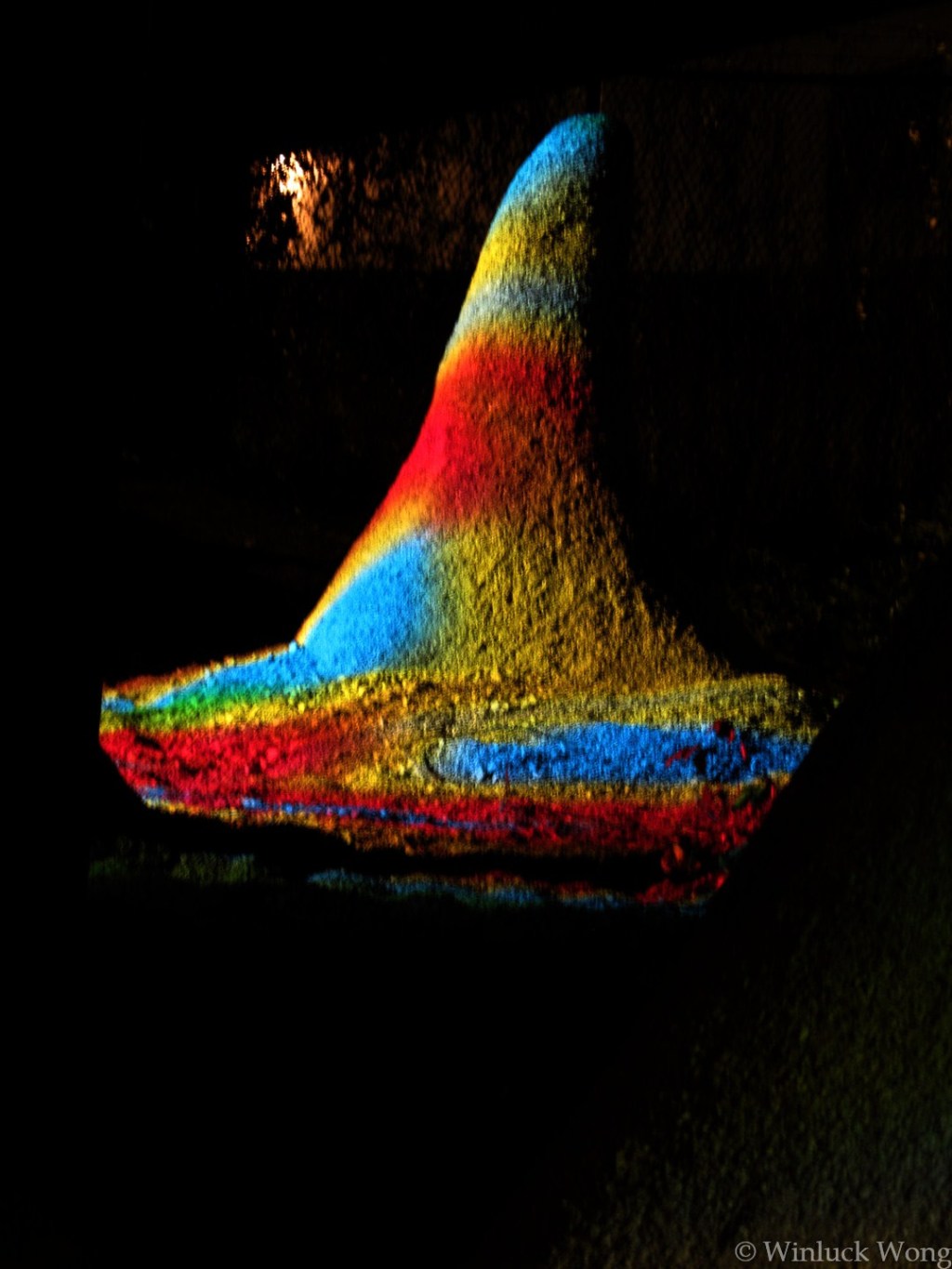 Rainbow light on rock sculpture photo for "Contact" poem by Winluck Wong, writer and poet based in New Brunswick